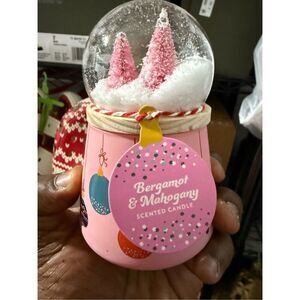 The 2023 Huntington Home Snow Globe Candle in Bergamot & Mahogany.
